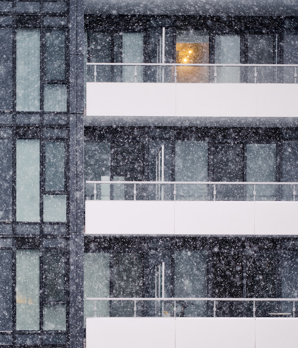 a tall building with windows covered in snow