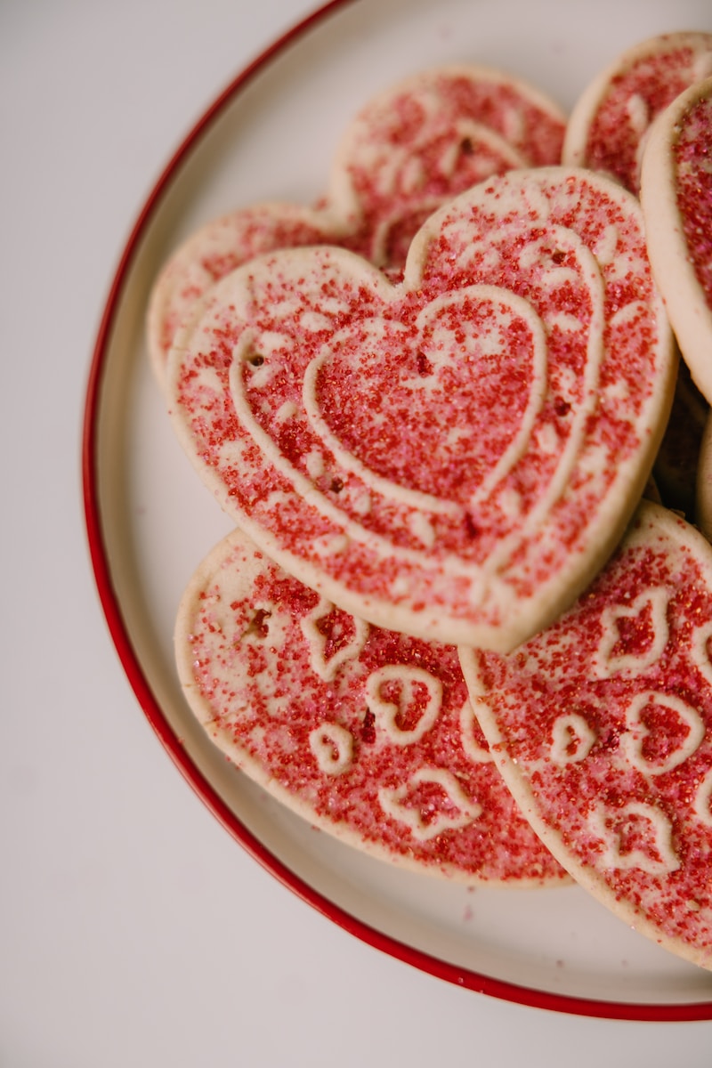 a plate of heart shaped cookies on a table