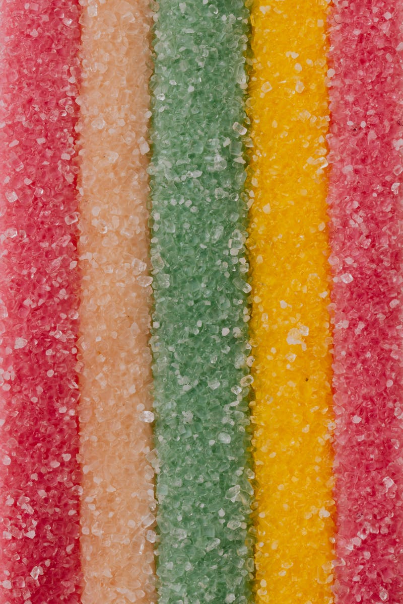 Multicolored background of yummy sprinkled sweets placed in vertical lines