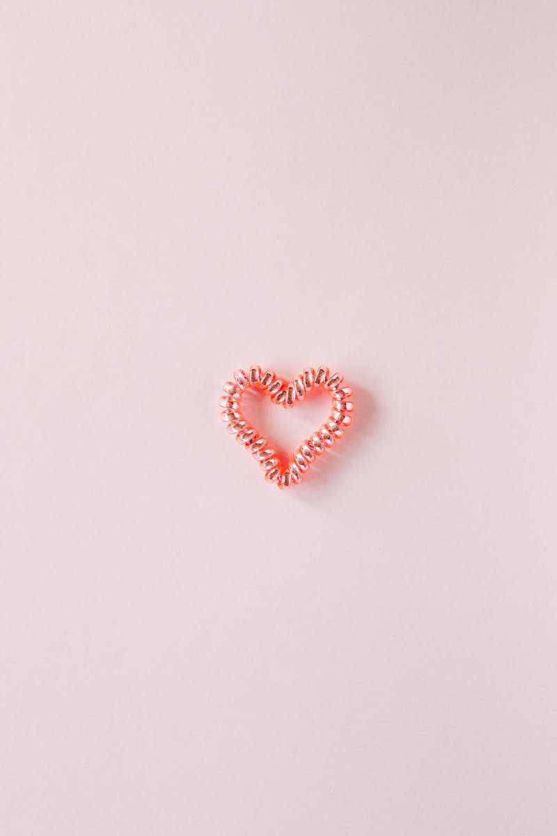 Small decorative heart on smooth pink surface