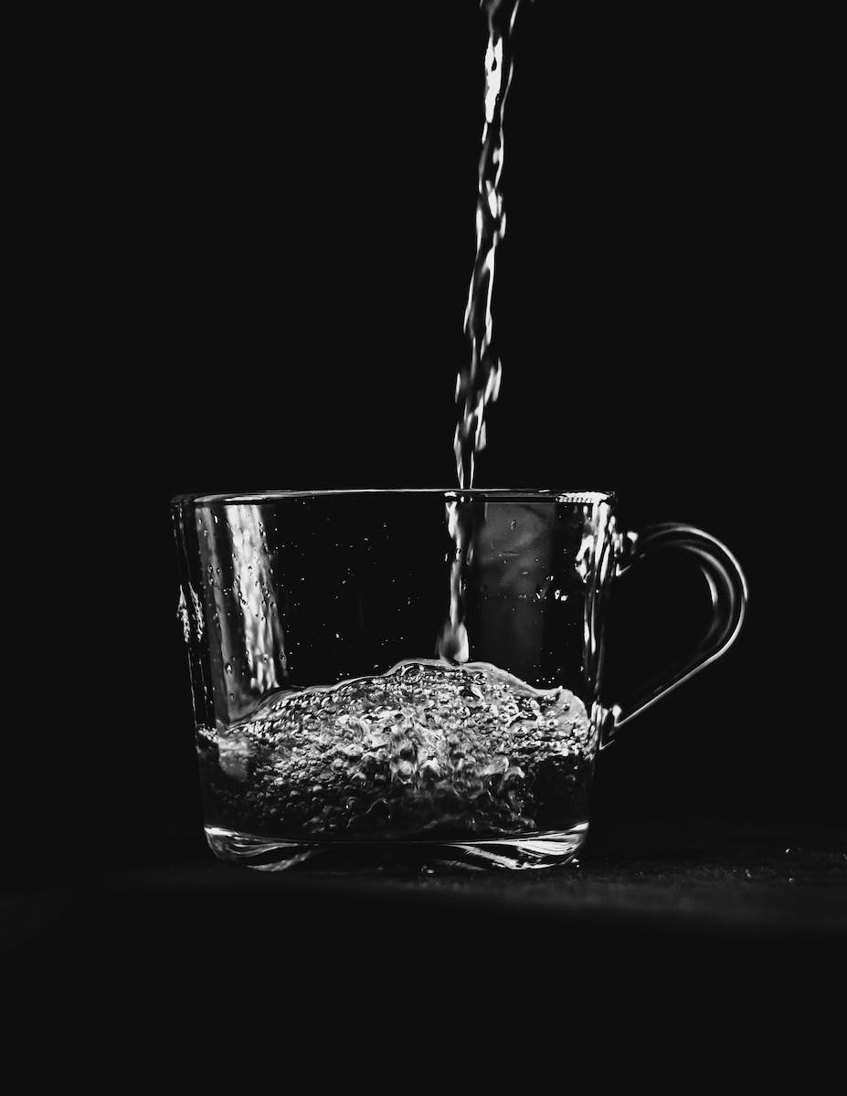 Water Pouring on Clear Glass Mug