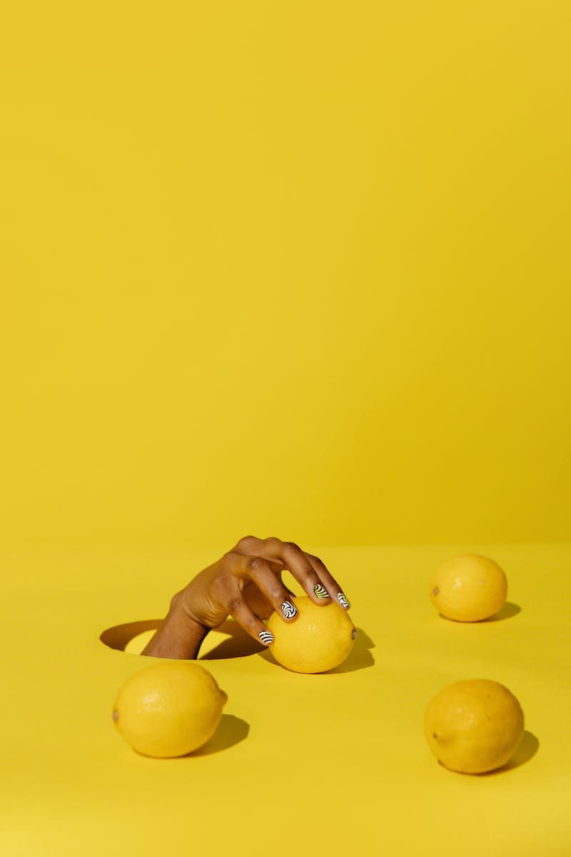 Person Holding a Lemon