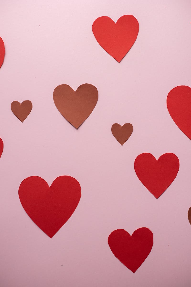 Paper hearts glued to pink wall