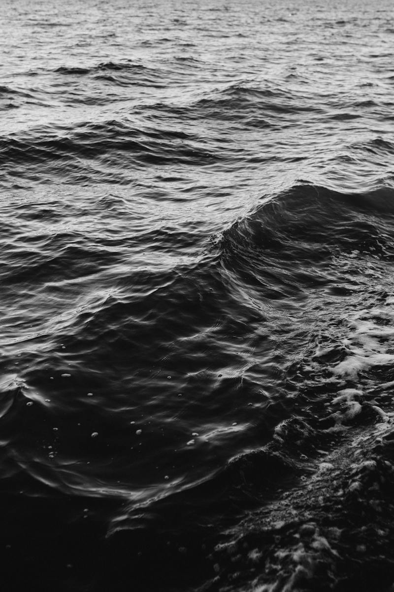 Grayscale Photo of Waves on the Ocean