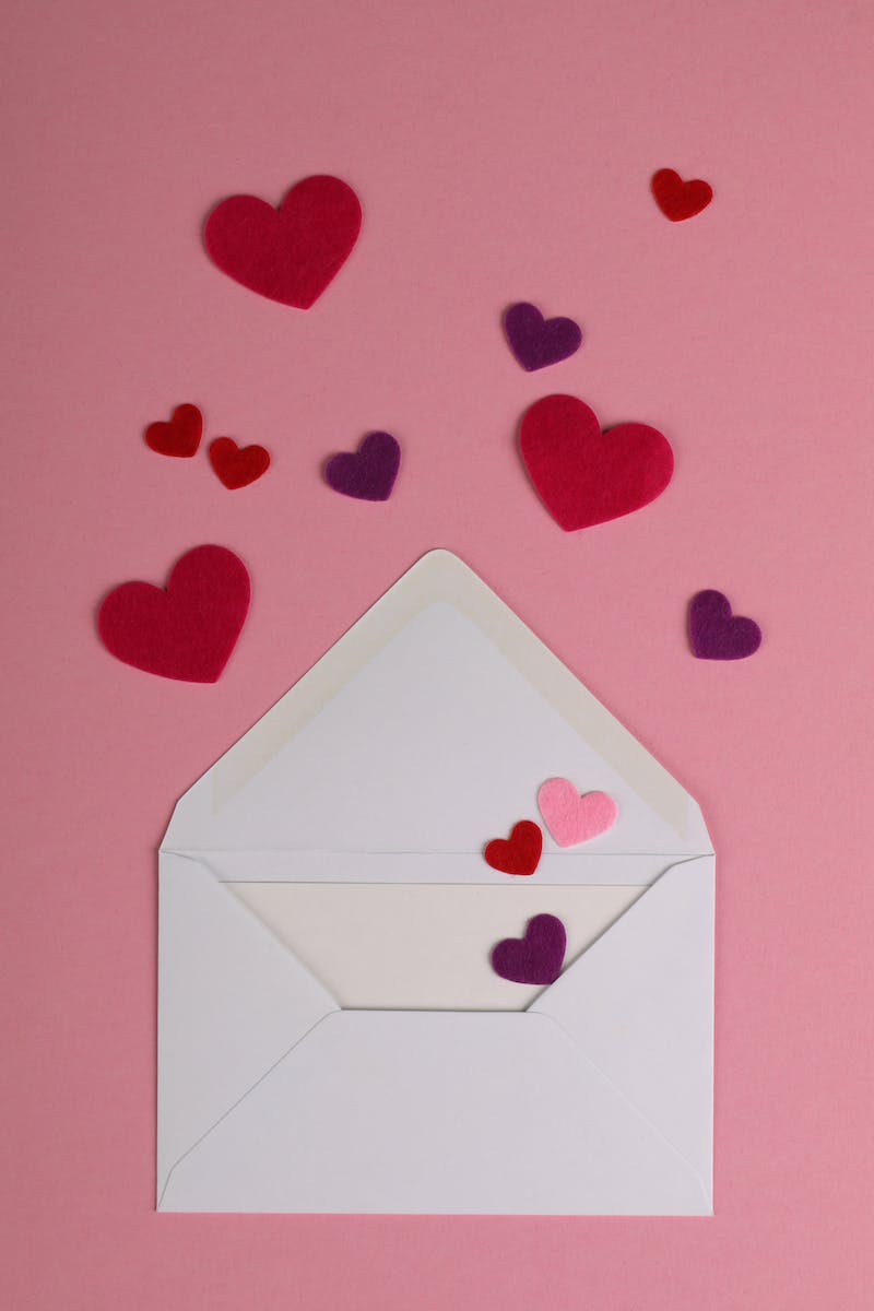 Photo of Hearts and an Envelope on a Pink Surface