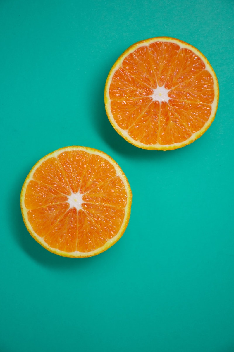 sliced orange fruit on blue surface