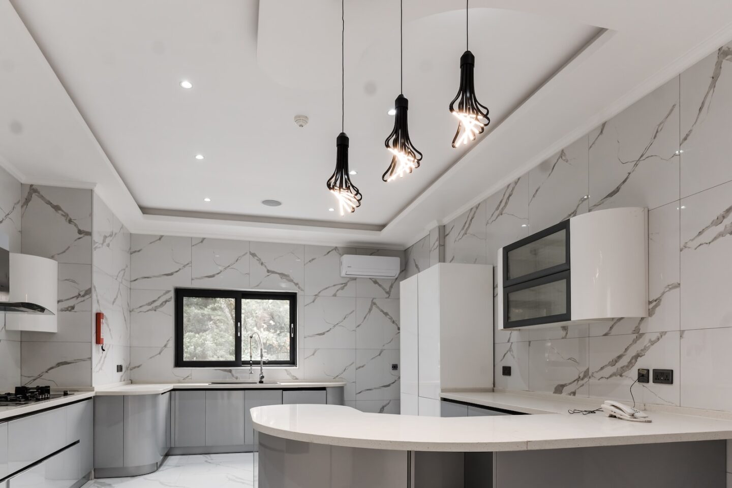 a kitchen with a marble counter top and white cabinets