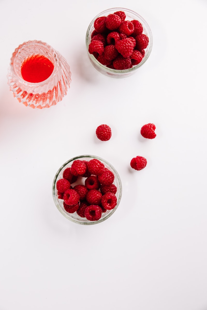 red strawberries in clear glass bowl