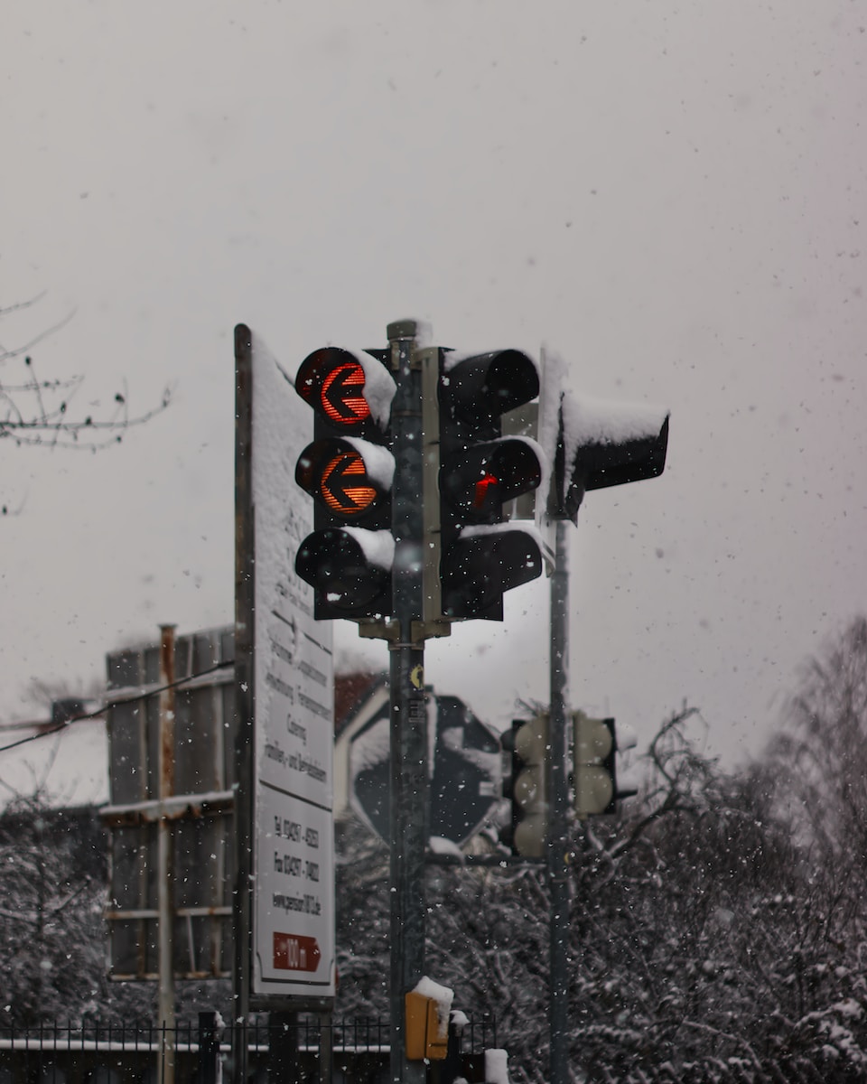 black traffic light on snow covered ground