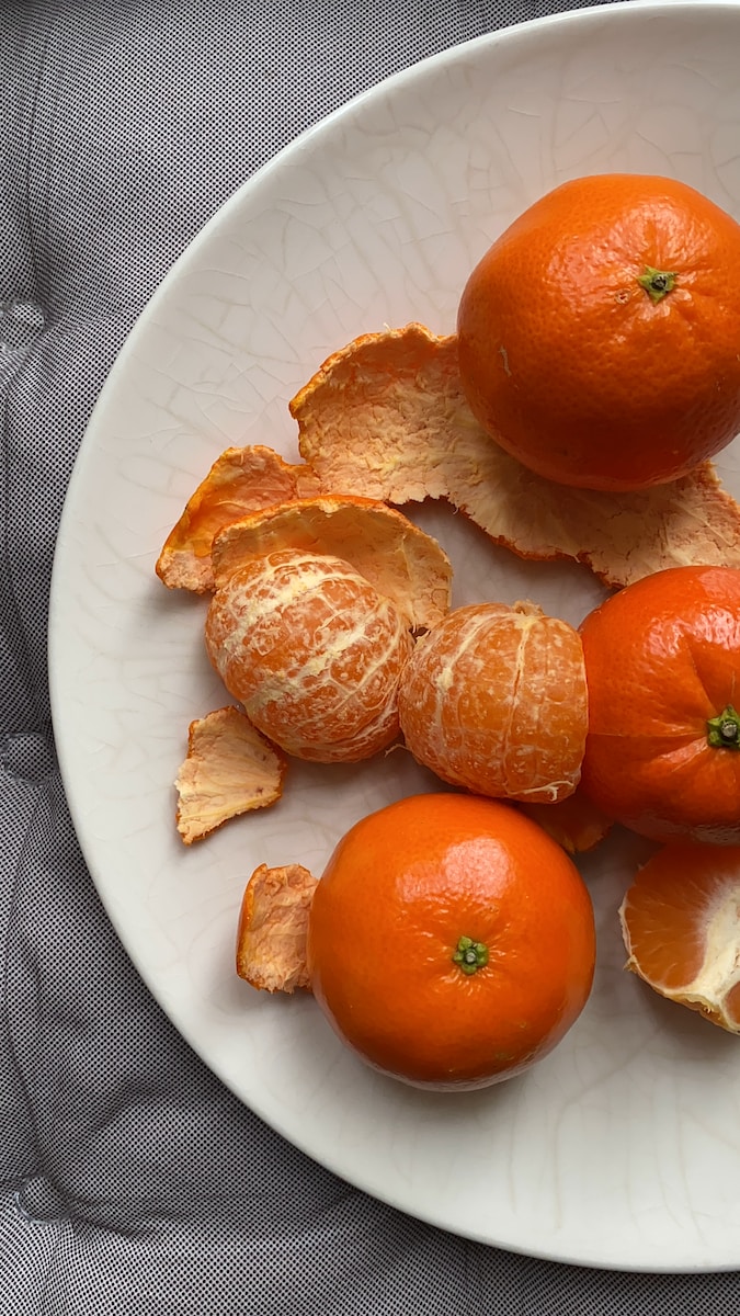 orange fruit on white ceramic plate