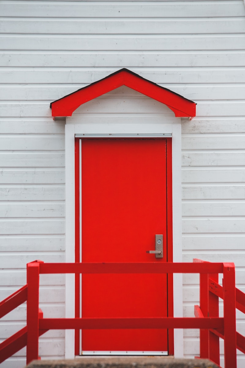 red wooden door on white wooden wall