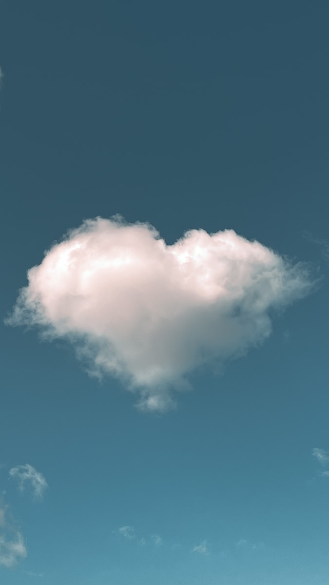 a cloud shaped like a heart in a blue sky