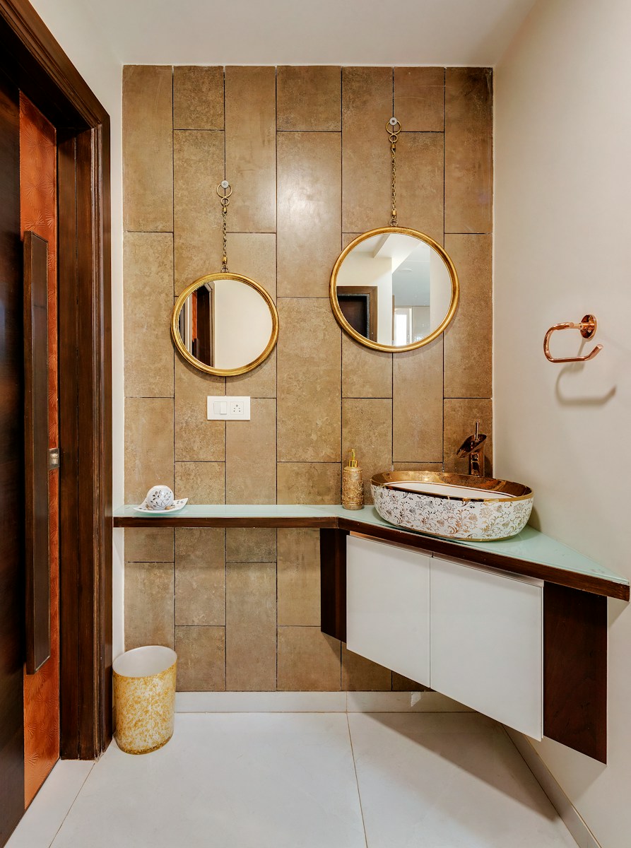 white ceramic sink beside brown wooden framed mirror