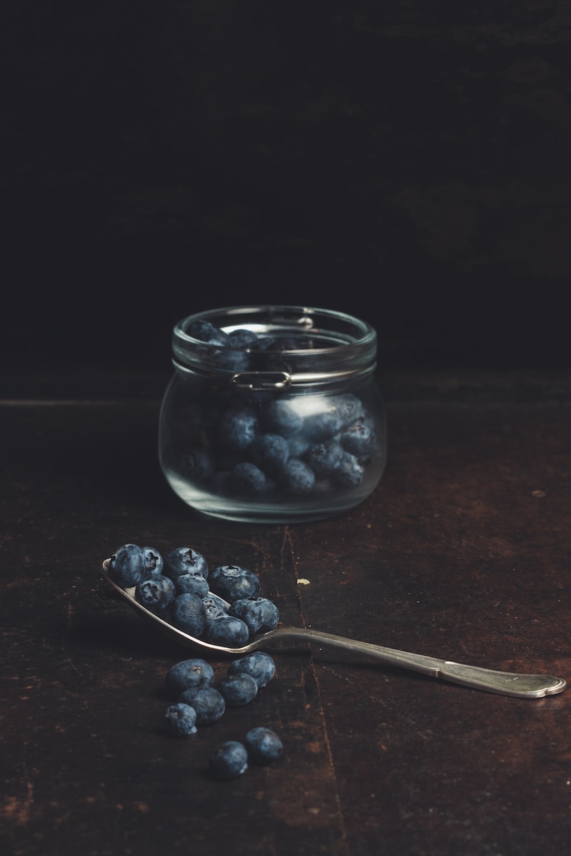 spoonful of blueberries from glass jar