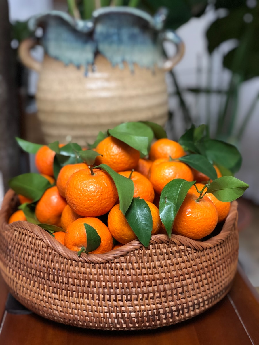 orange fruits on brown woven basket