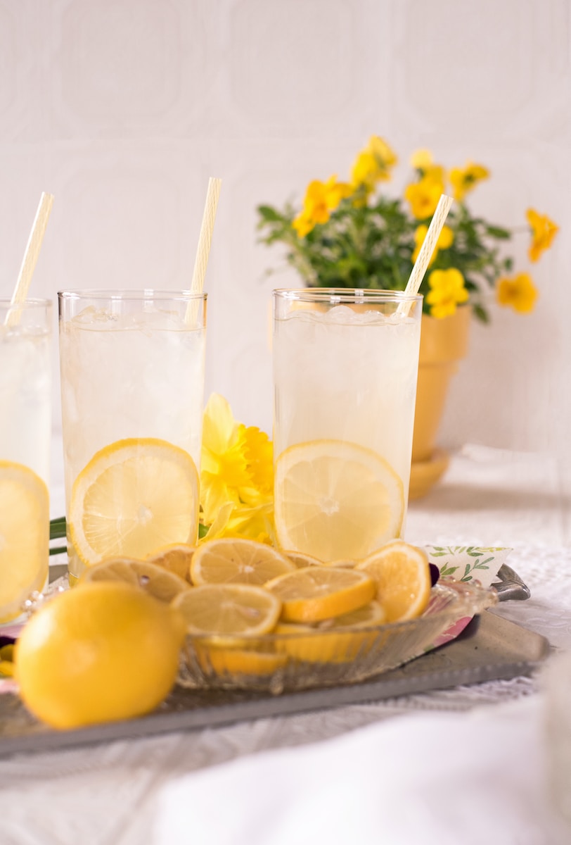 sliced lemon beside two clear drinking glasses