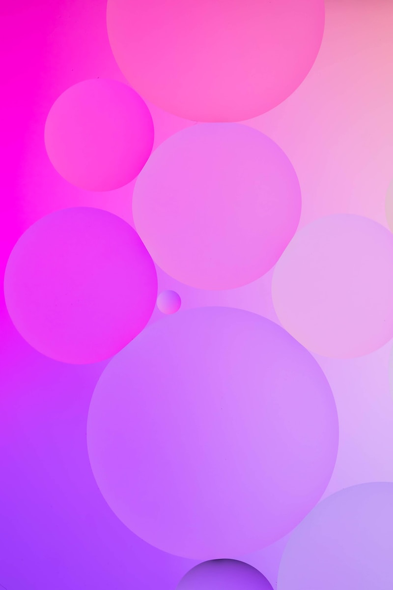 a pink and purple abstract background with circles