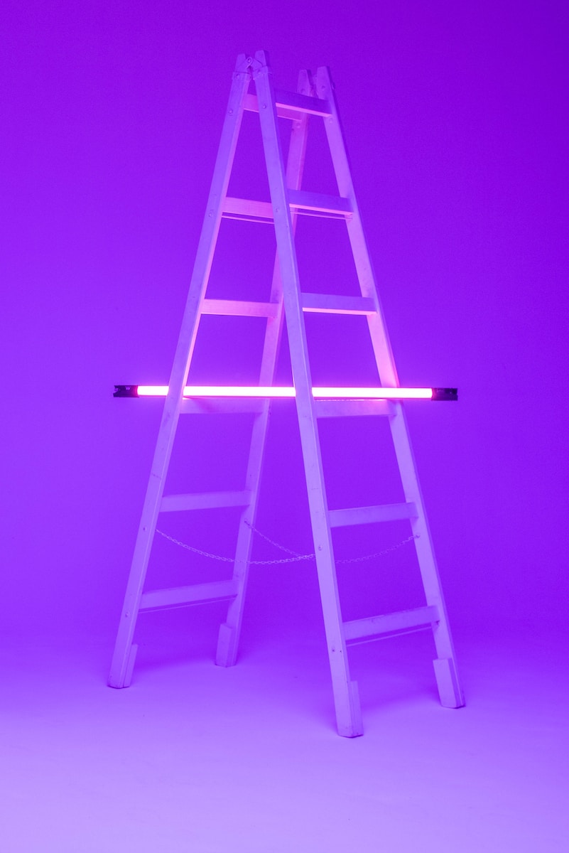 turned-on fluorescent lamp on folding ladder