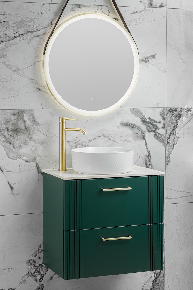 a bathroom vanity with a round mirror above it