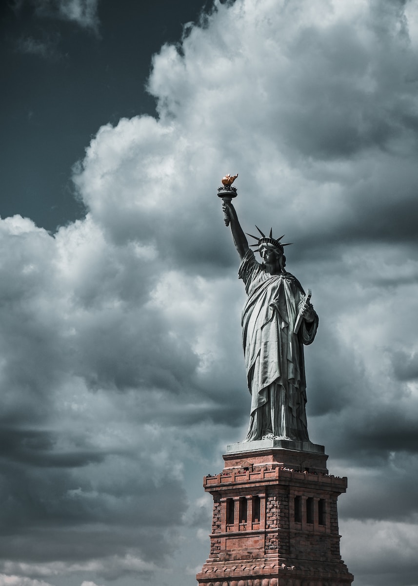 Statue of Liberty under cloudy sky during daytime