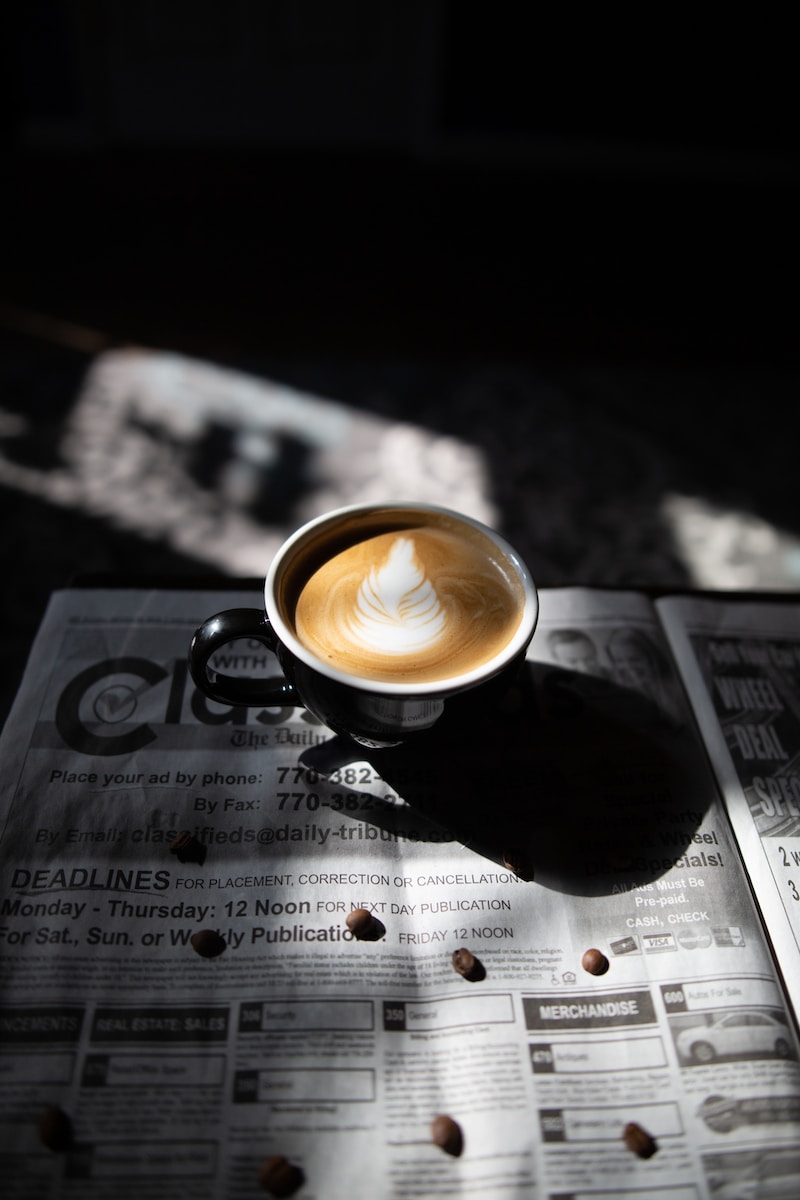 selective focus photography of latte art in black ceramic cup