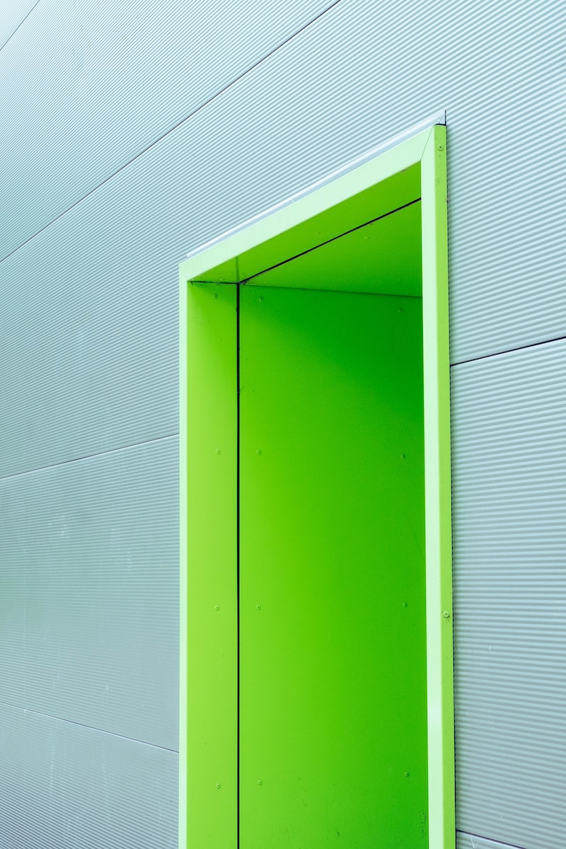 green door with gray wall