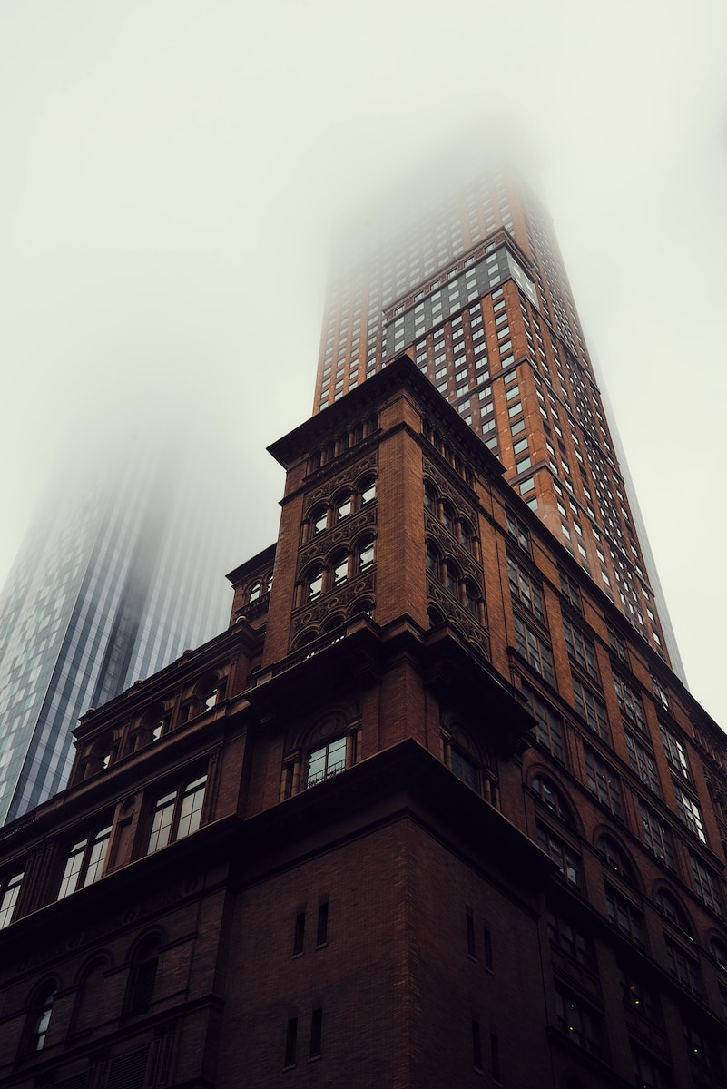 brown building half-covered with fog