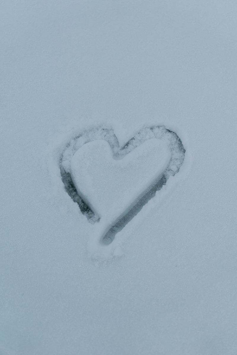 a heart drawn in the snow on a snowy day