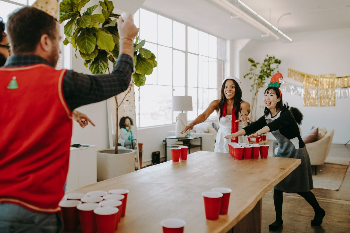 Happy Colleagues playing Beer Pong