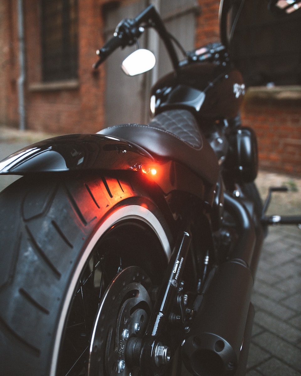 black and red motorcycle on road during daytime