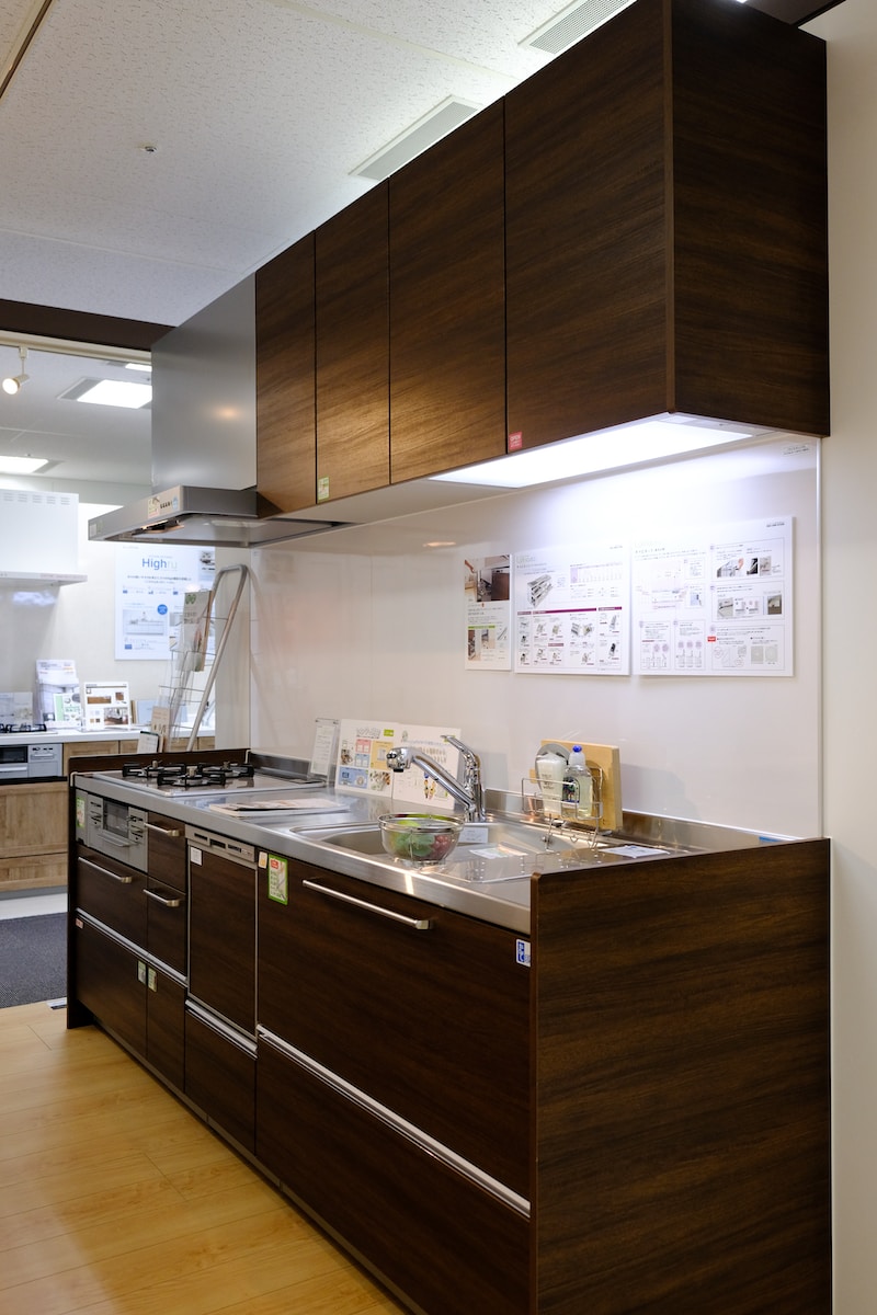 brown wooden kitchen cabinet with white wall mounted kitchen cabinet