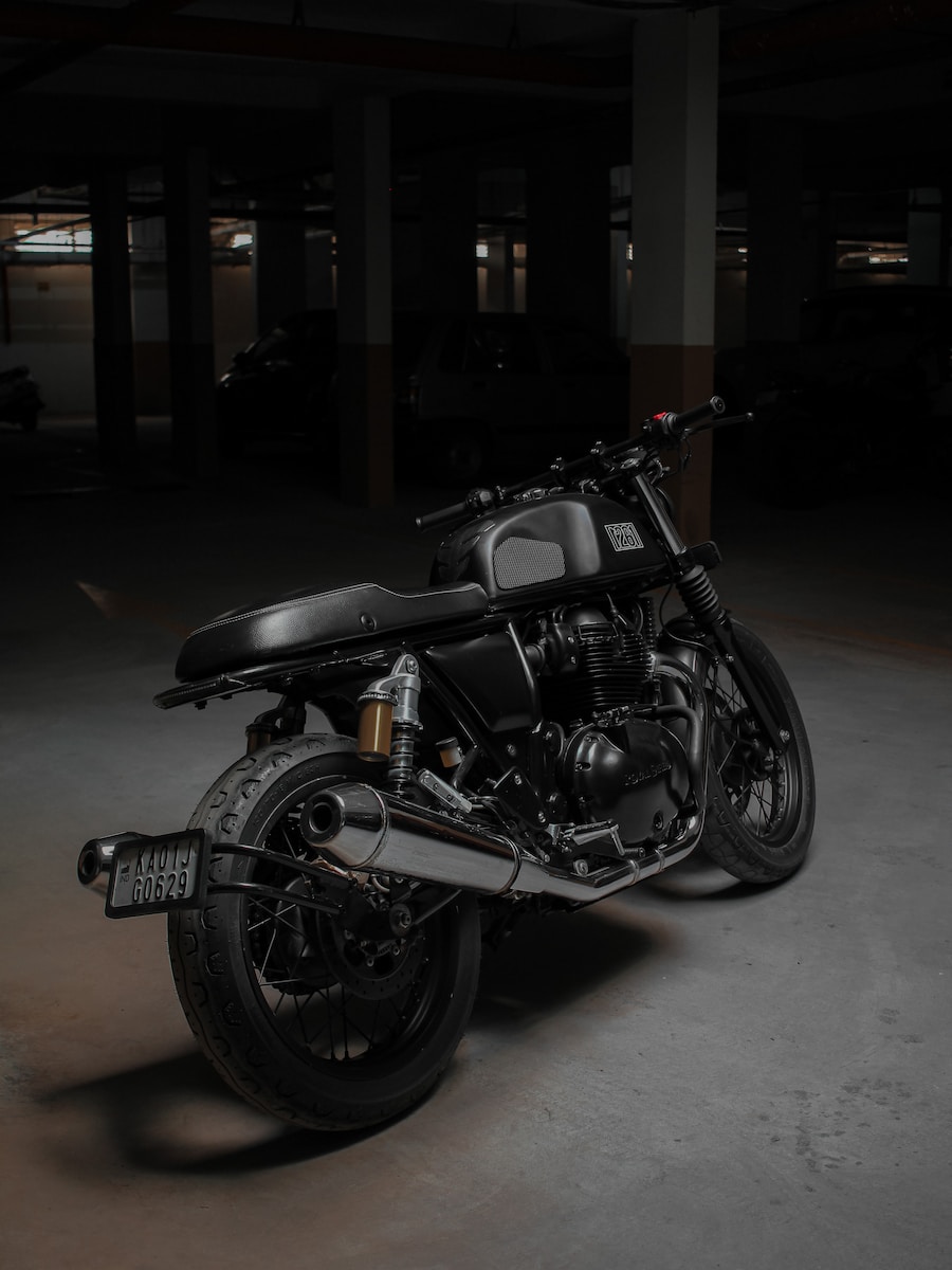 a black motorcycle parked in a parking garage