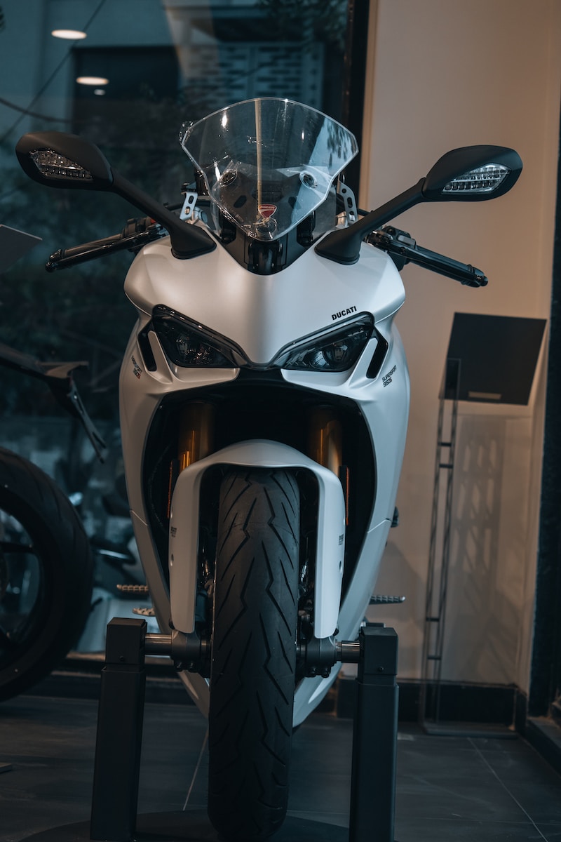 a white motorcycle parked inside of a building