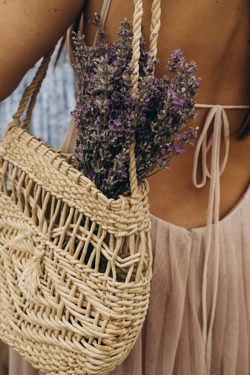 woman in white tank top holding brown woven basket