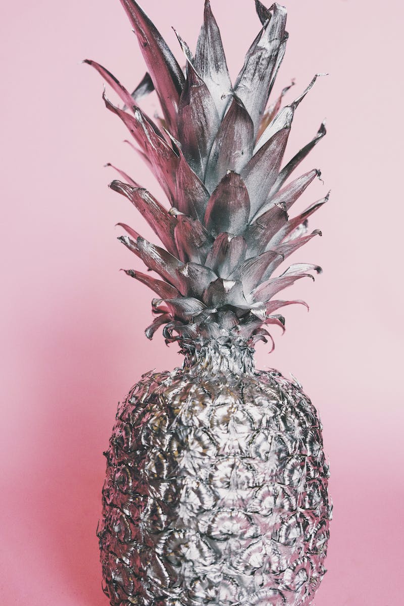 Close-up Photo of Silver Painted Pineapple Against Pink Background