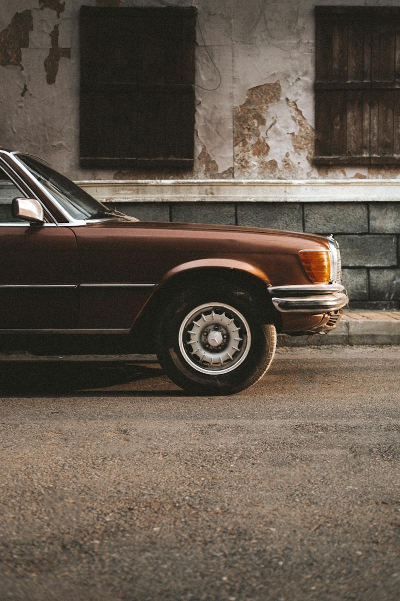 A brown car parked on the side of the road