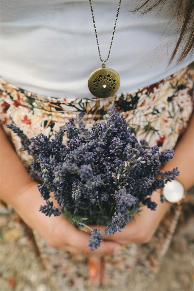 Person Holding Bundle of Purple Flowers