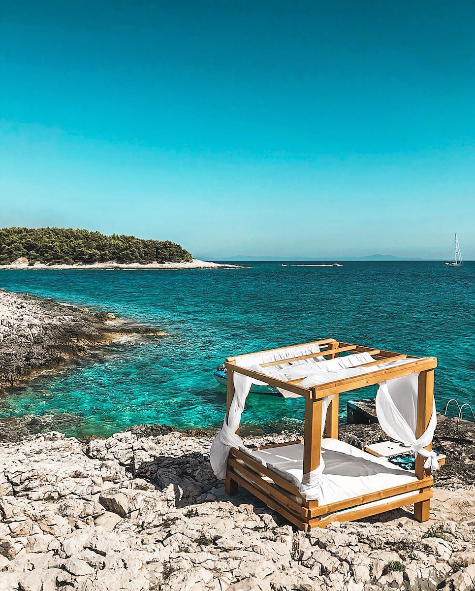 White and Brown Wooden Table Nearby Seashore