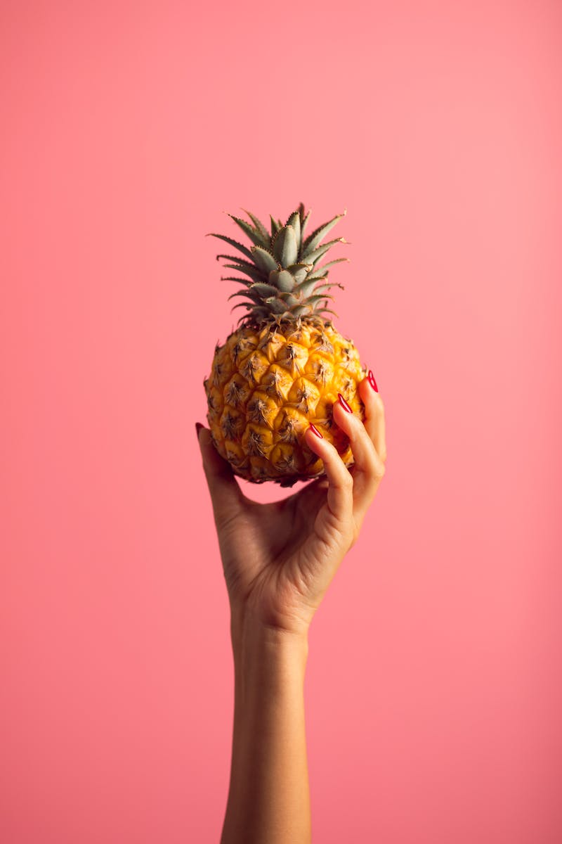Person Holding Pineapple Fruit