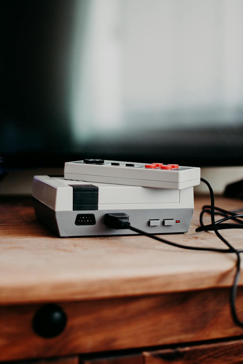 Photo of Video Game Console on Brown Wooden Table