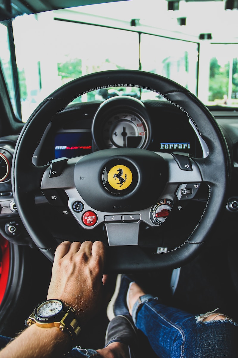 person driving Ferrari vehicle