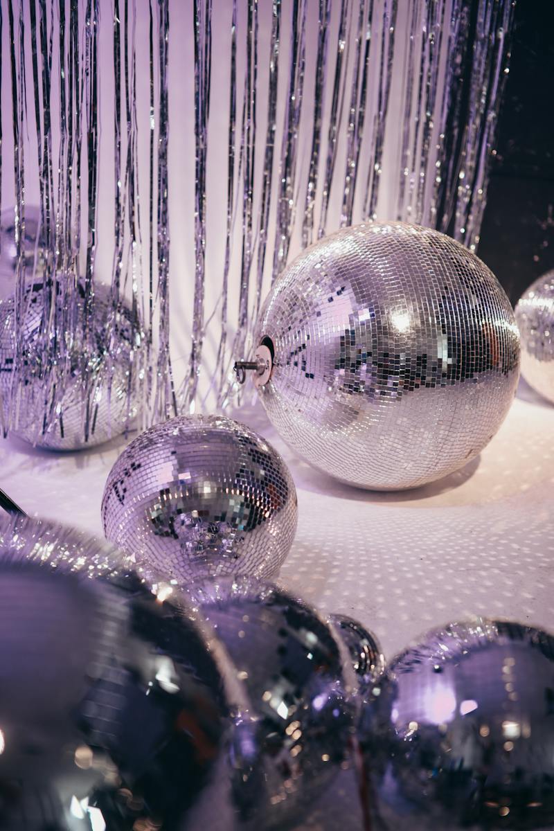 Silver and Purple Baubles on White Textile