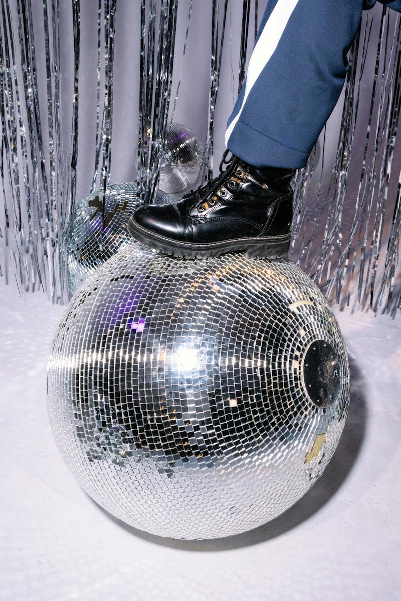 Photo of a Person's Foot on a Disco Ball