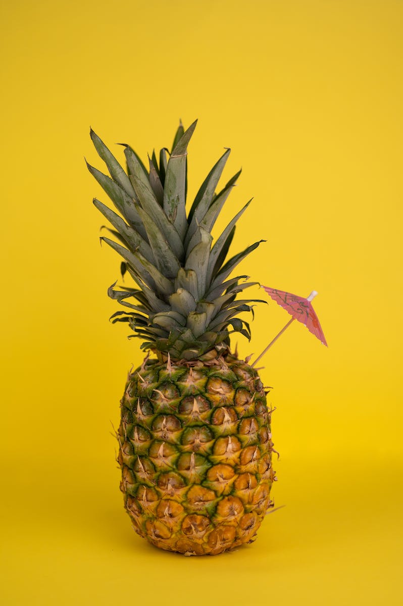 Whole pineapple with cocktail umbrella