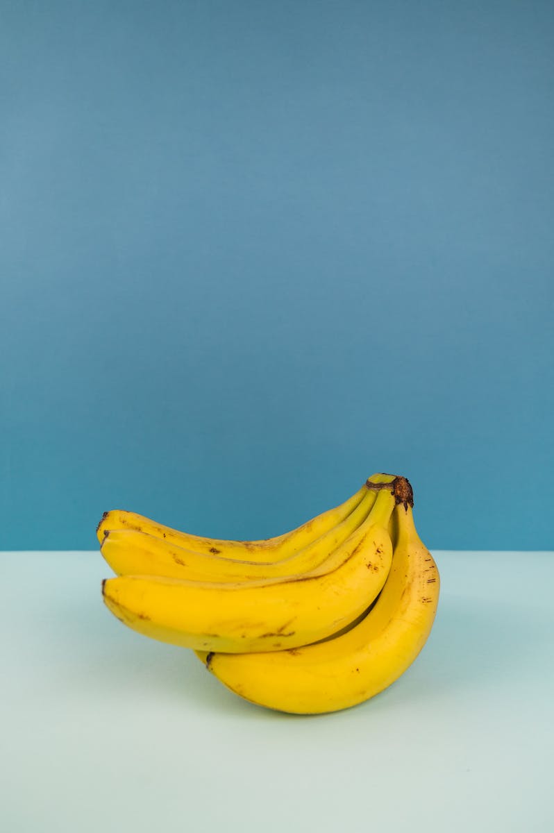 Bundle of fresh bananas on two color background