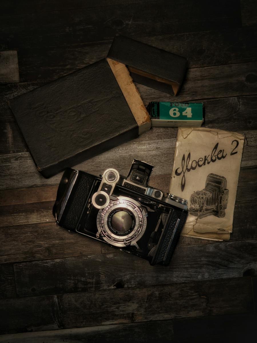 Black and Silver Camera on Brown Wooden Table