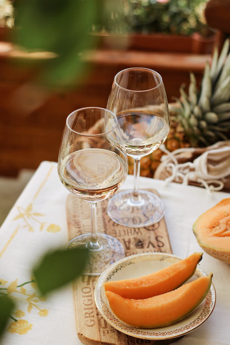Fruits and wineglasses on table