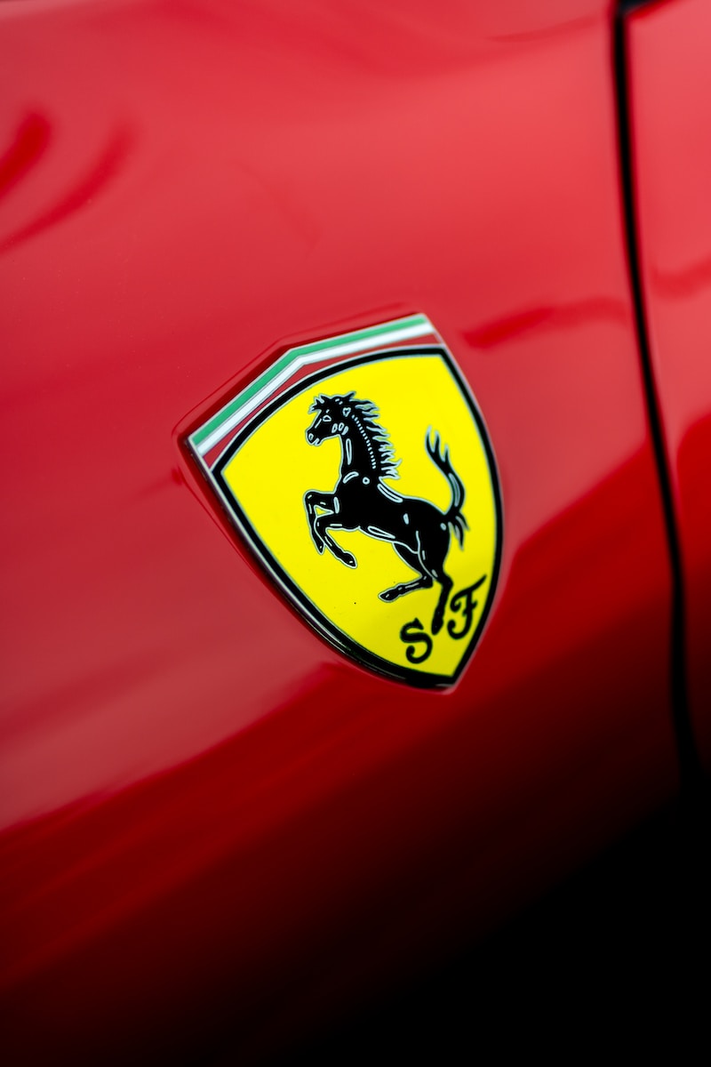 a close up of a ferrari badge on a red car