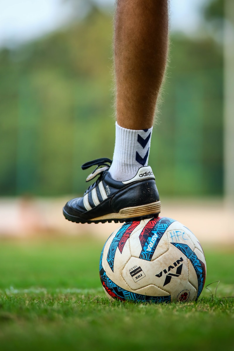 a close up of a person's feet on a soccer ball