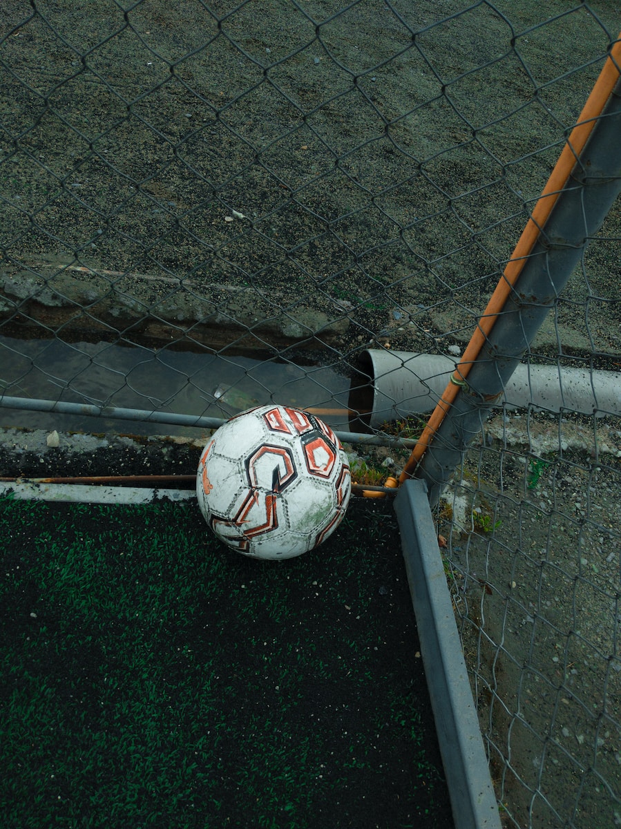 white and orange soccer ball
